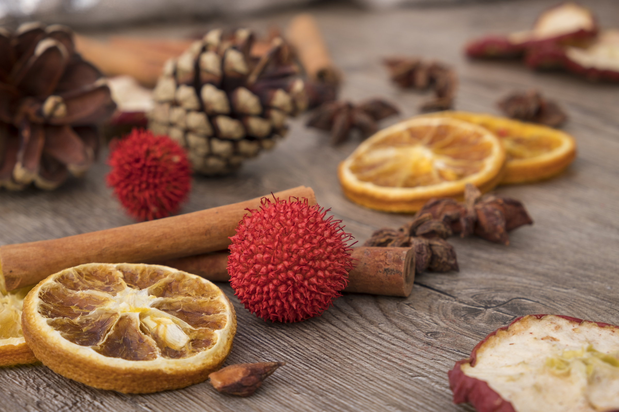 Cinnamon Sticks and Dried Fruits on Wooden Background